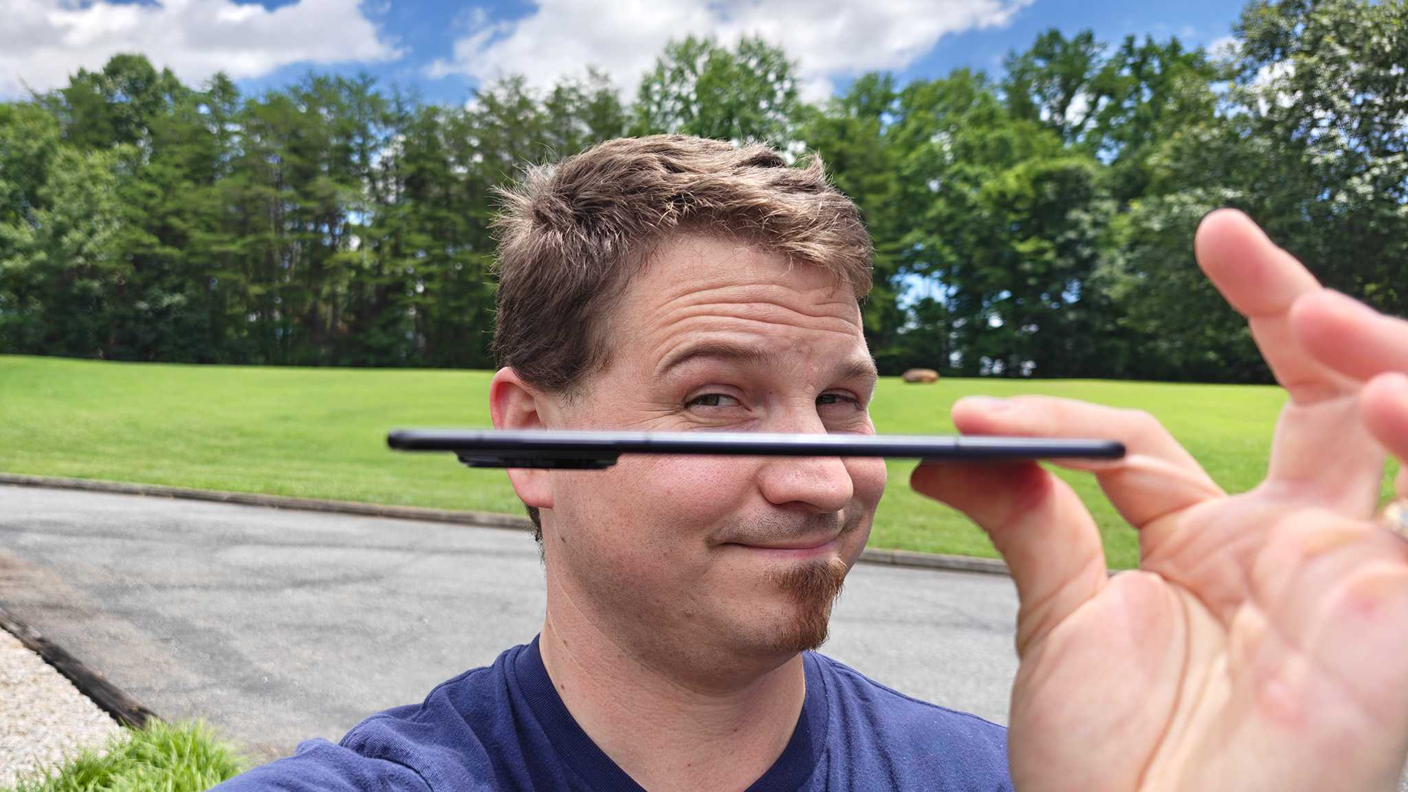 Holding an Honor Magic V3 showing its ultrathin build