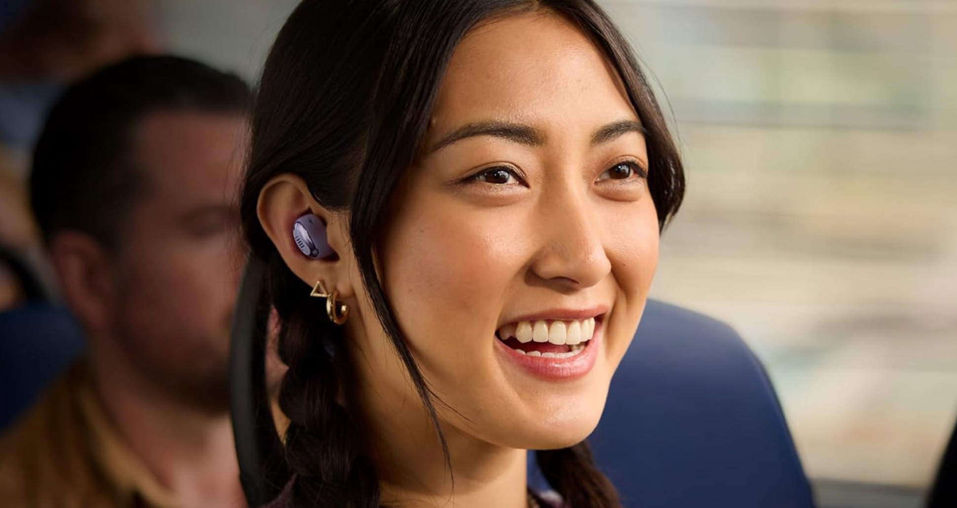 A person with a JBL earbud in their ear